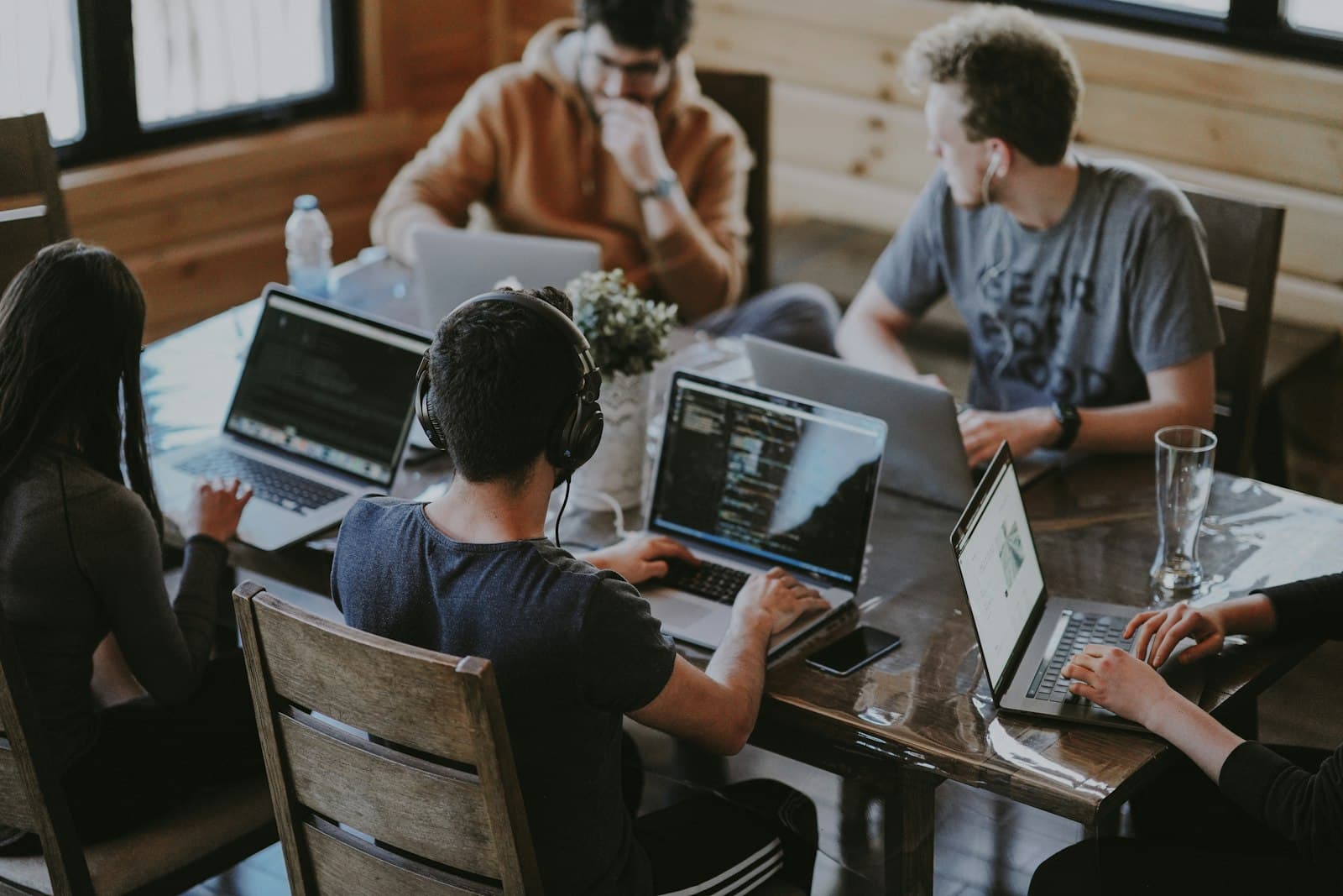 A small team gathered around a laptop discussing enterprise search software options
