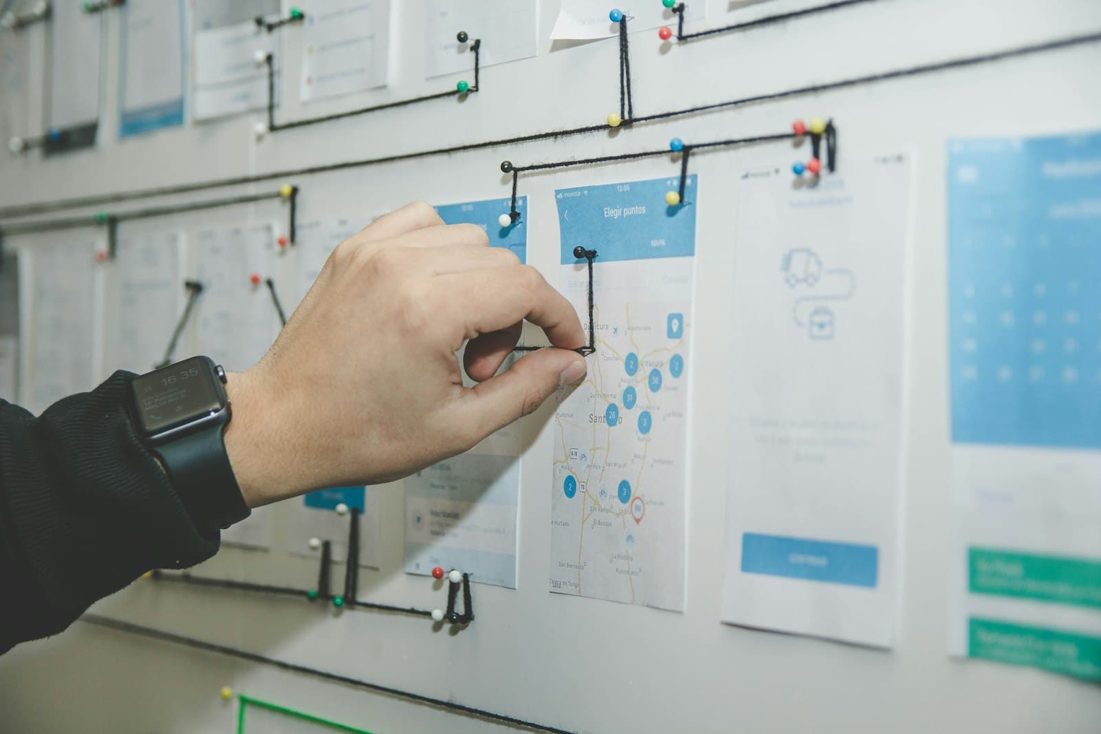A team gathered around an office whiteboard covered in planning notes, illustrating context engineering as a deliberate design discipline