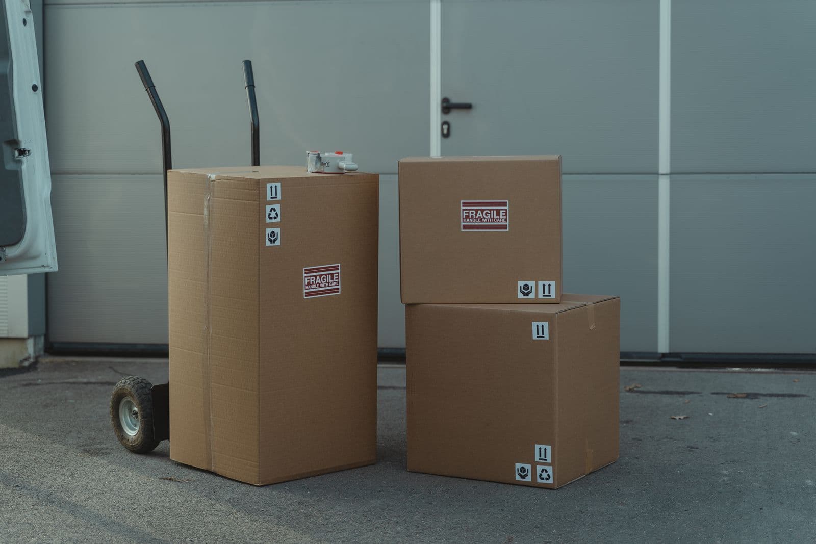 Stacked fragile moving boxes on a hand truck, representing the process of migrating off zep community edition to a new self hosted memory layer
