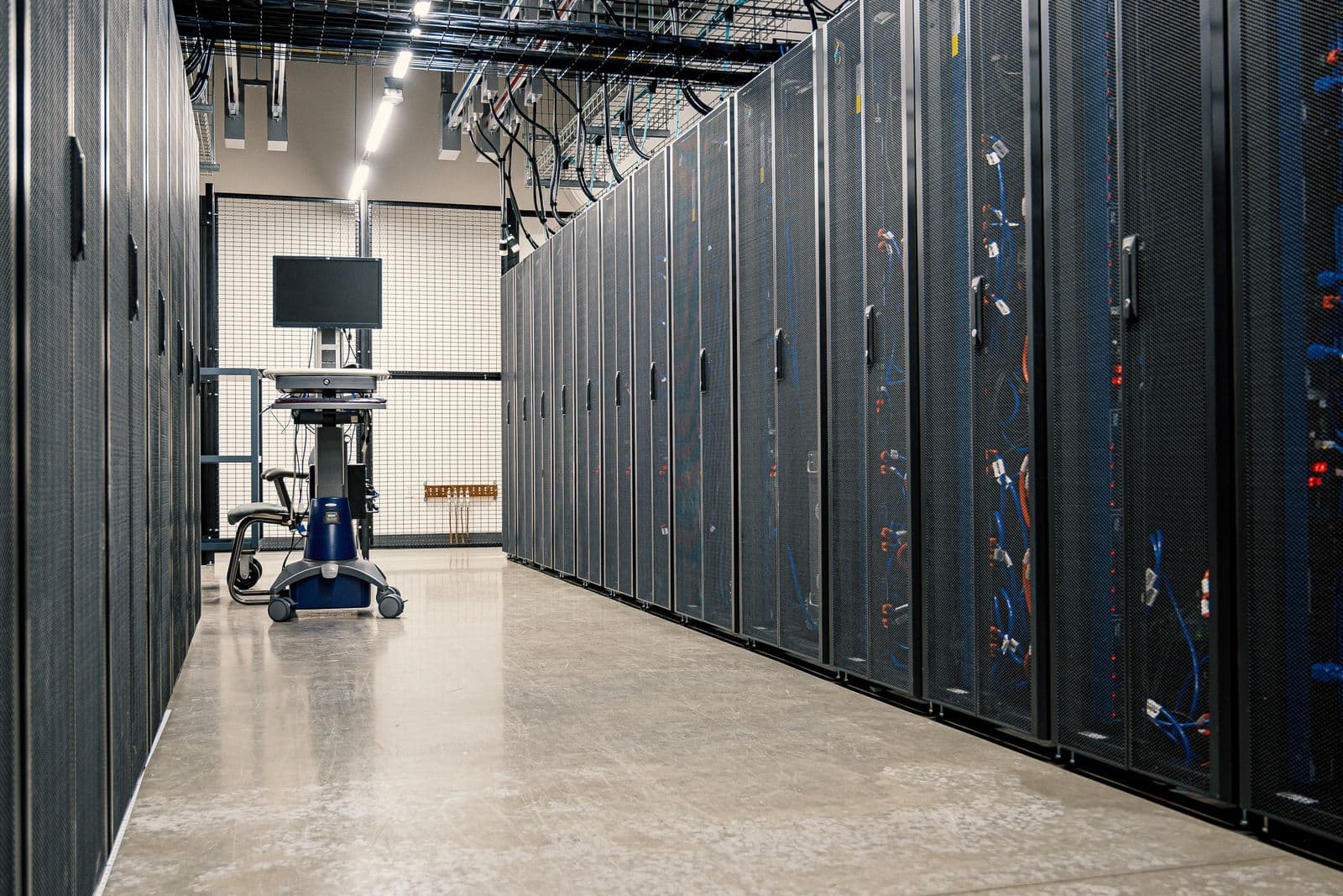 A data centre corridor lined with server cabinets, representing what self hosted mcp governance actually runs on